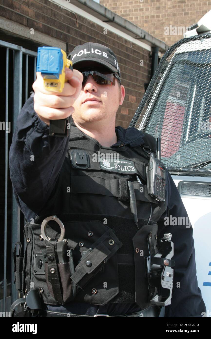 police officer with taser Stock Photo