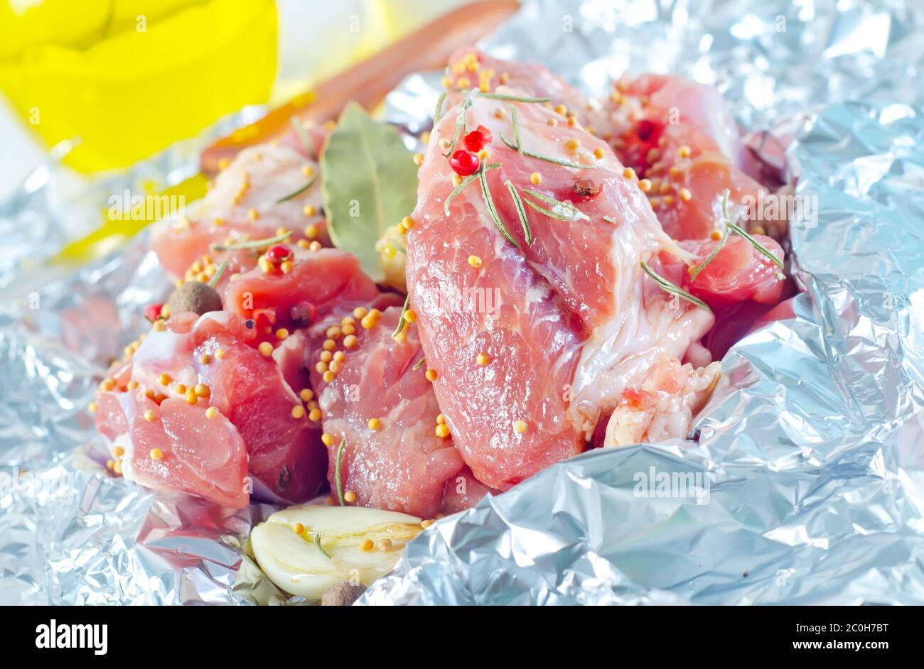 raw meat in the foil Stock Photo Alamy