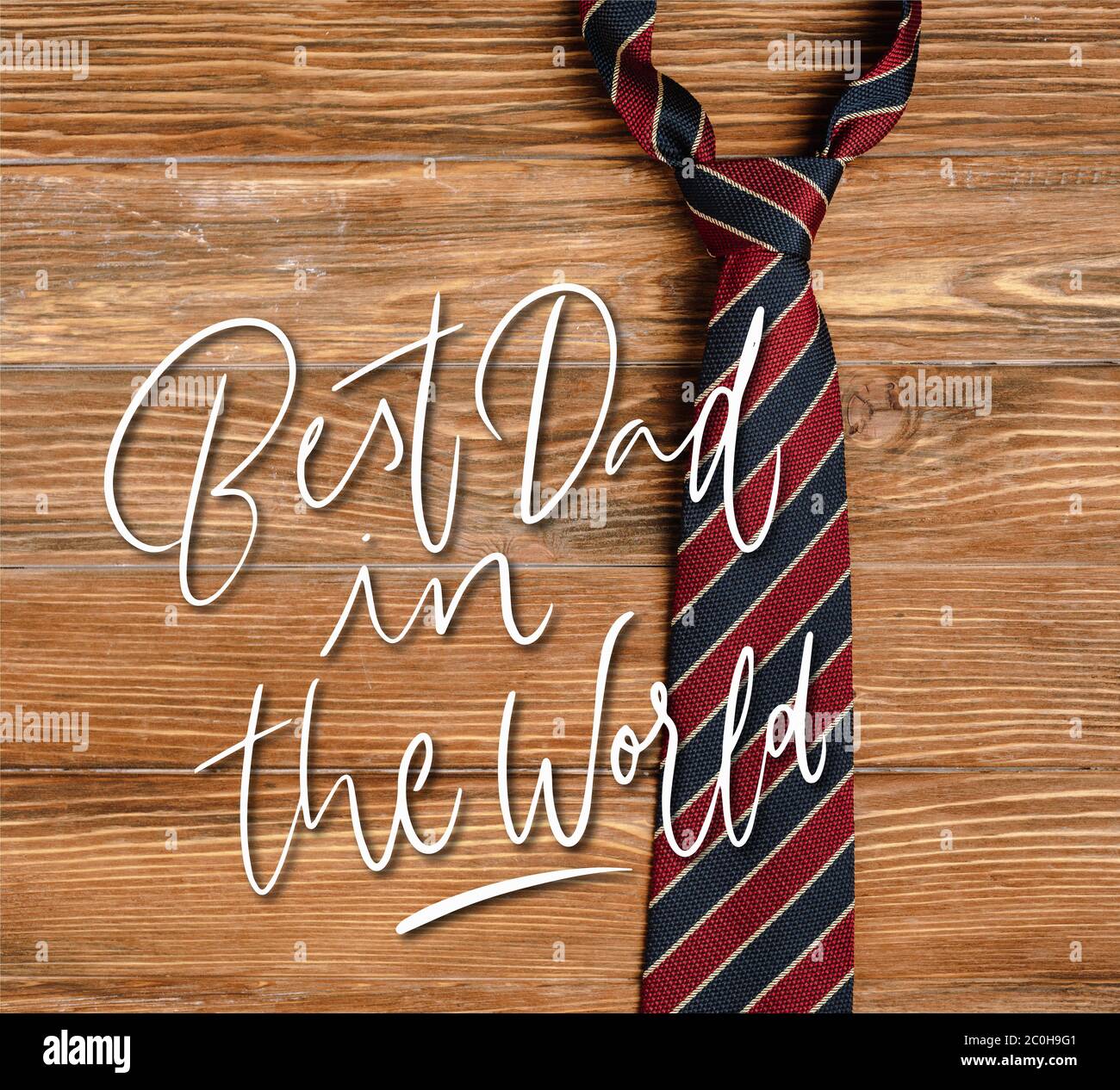 Top view of mens striped fabric tie on wooden background, best dad in the world illustration ...