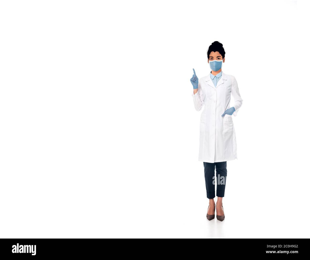 african american  doctor with illustrated face in medical mask pointing with finger on white Stock Photo