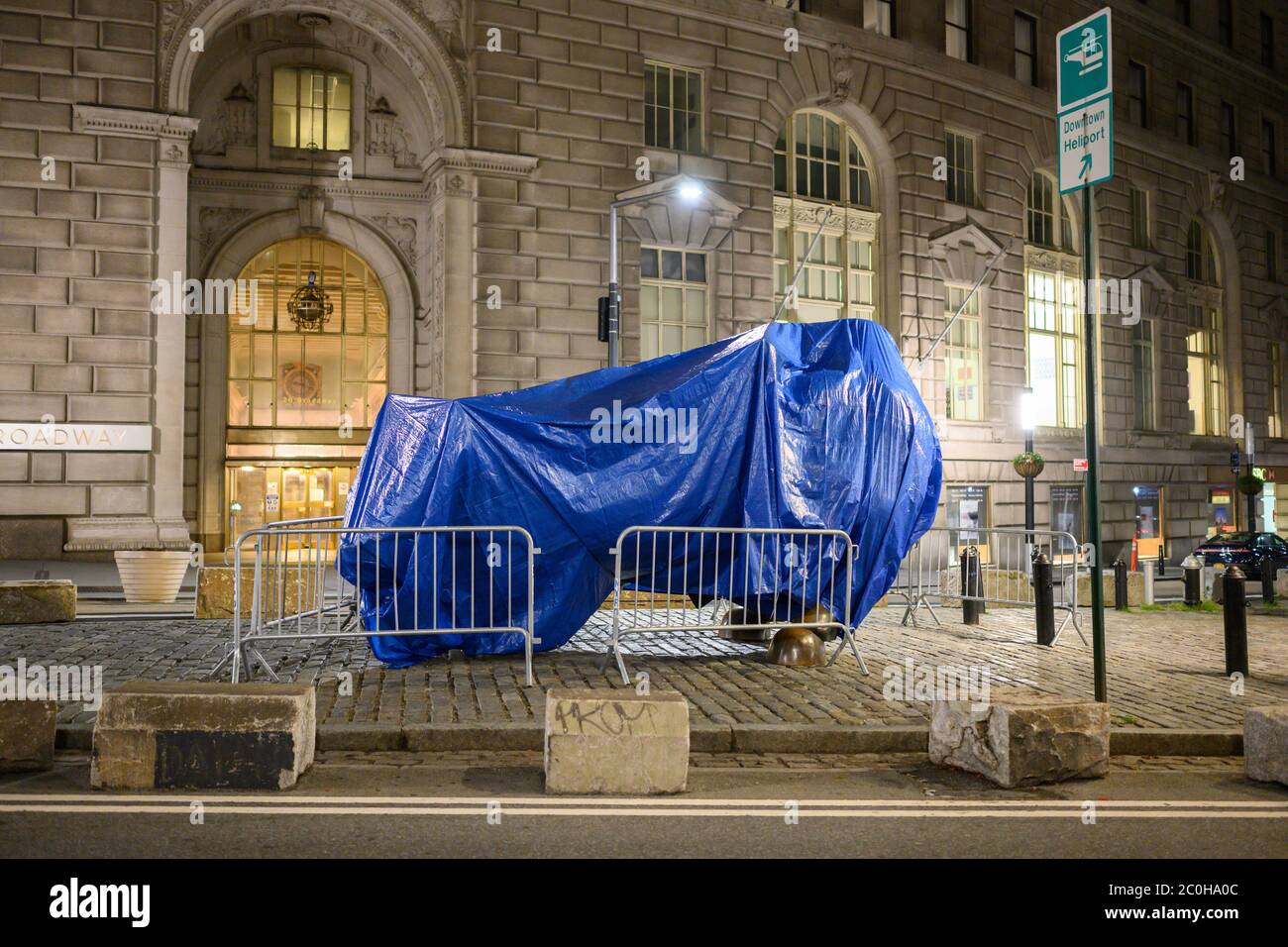 The famous Wall Street Bull covered up. Presumably to keep crowds away attempting to take photos during the pandemic. Stock Photo