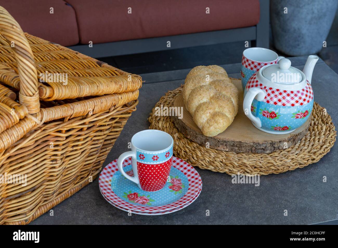 High tea picnic concept with decorated tea pot, teacups and picnic