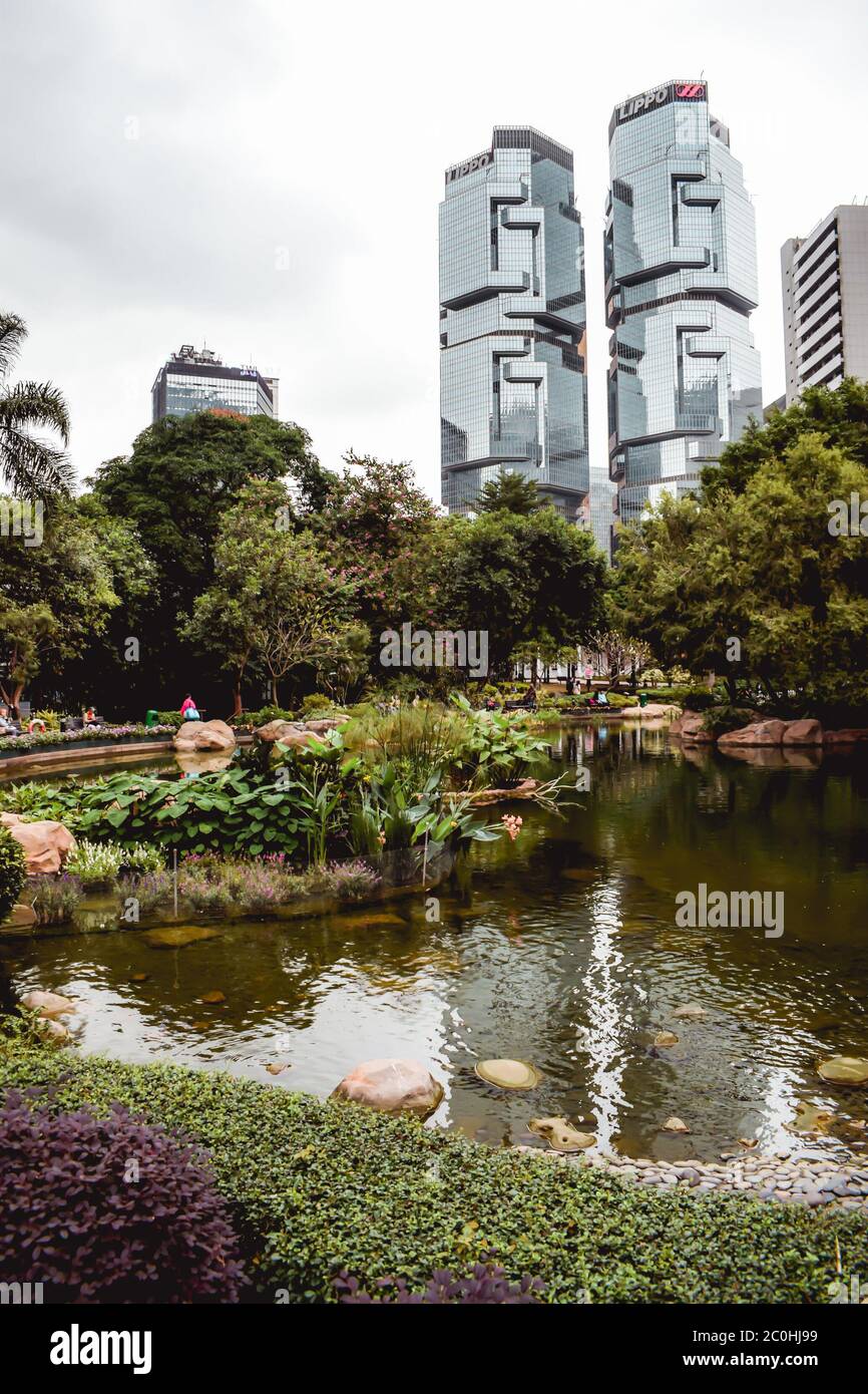 View at the Lippo Center twin buildings over the lake in the Hong Kong Park Stock Photo