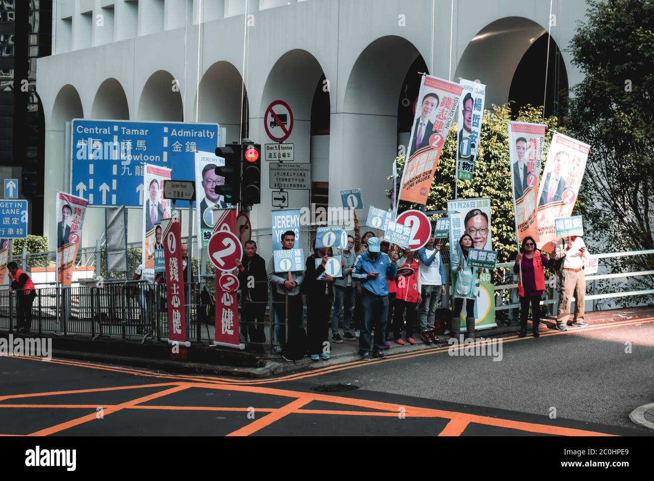 Group of political supporters marching the streets of Hong Kong to support their candidate before the elections Stock Photo