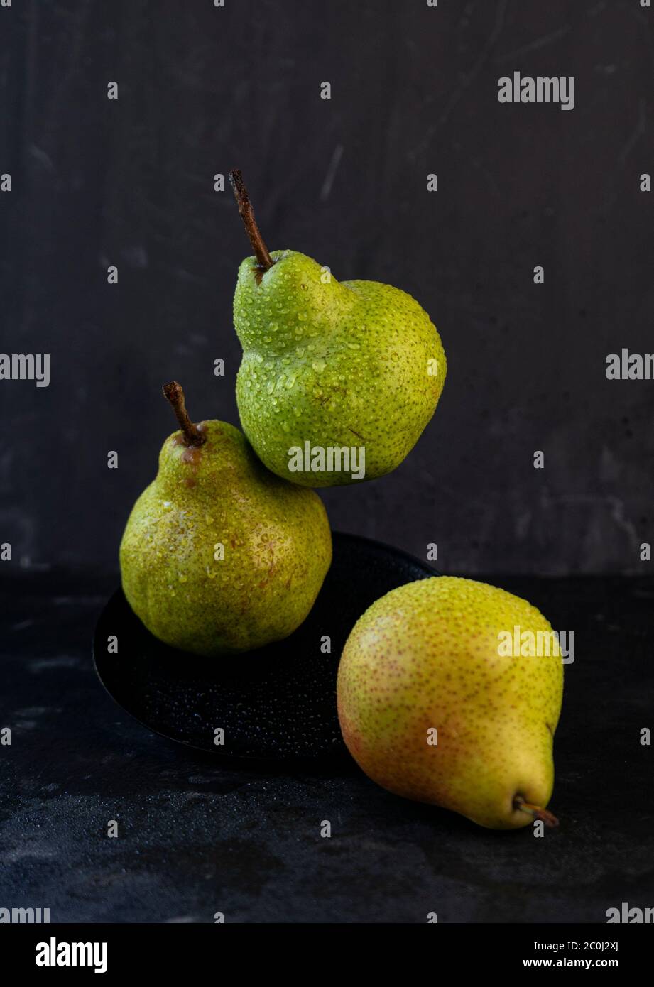 selective focus: large ripe pears with water drops on a dark background Stock Photo