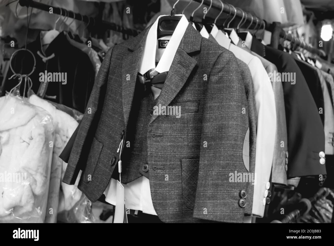 Stylish Little Gantleman Suits Hanging On A Clothes Hanger In A Line On