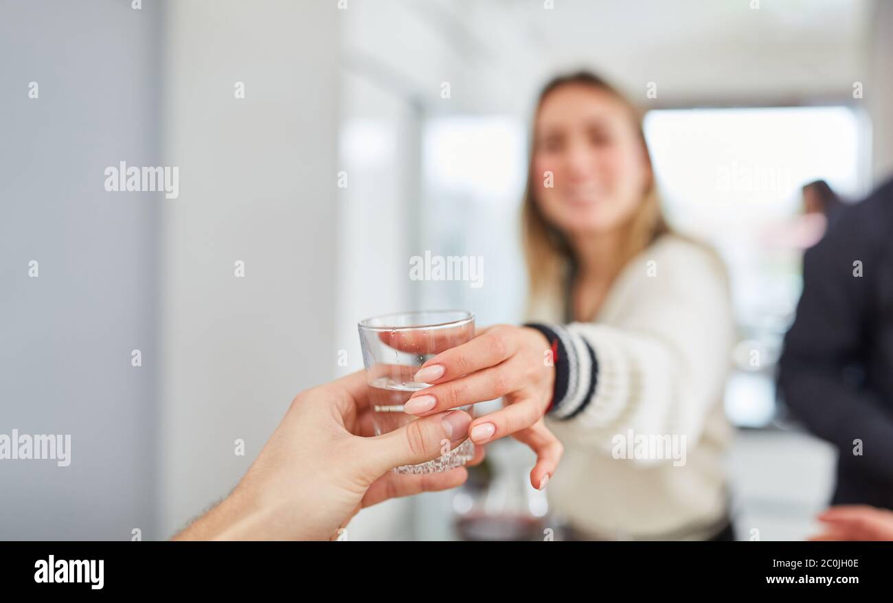 Reach someone the water as a saying with woman at the table Stock Photo