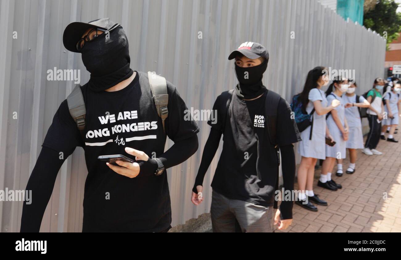 Hong Kong China 12th June Males Clad In Black T Shirts Printed With Slogan We Are Hong Kongers Walk Past An Iron Fence Outside Heung To Middle School Where Students Staged A