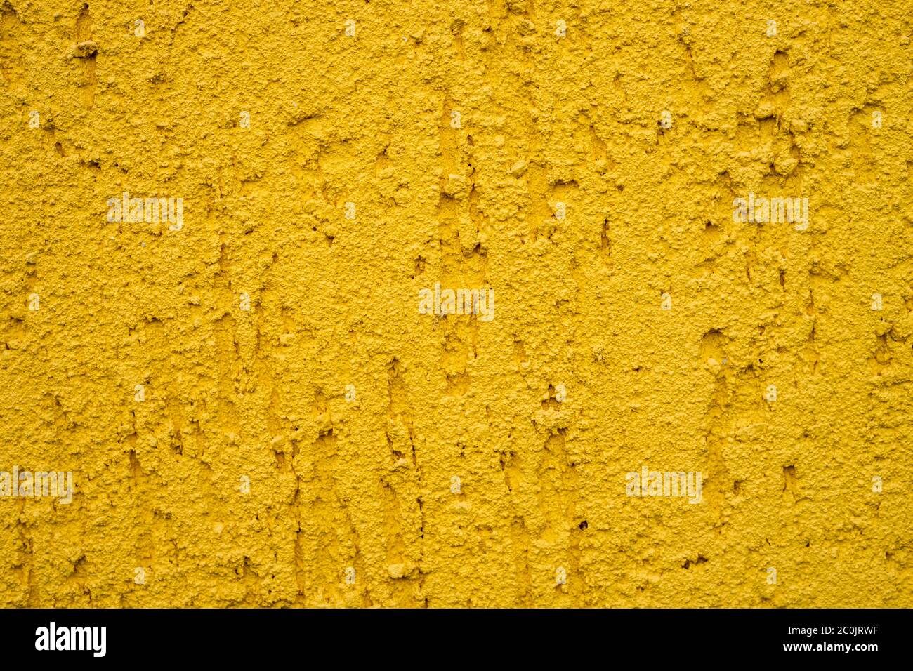 Background of yellow stone wall with drips Stock Photo