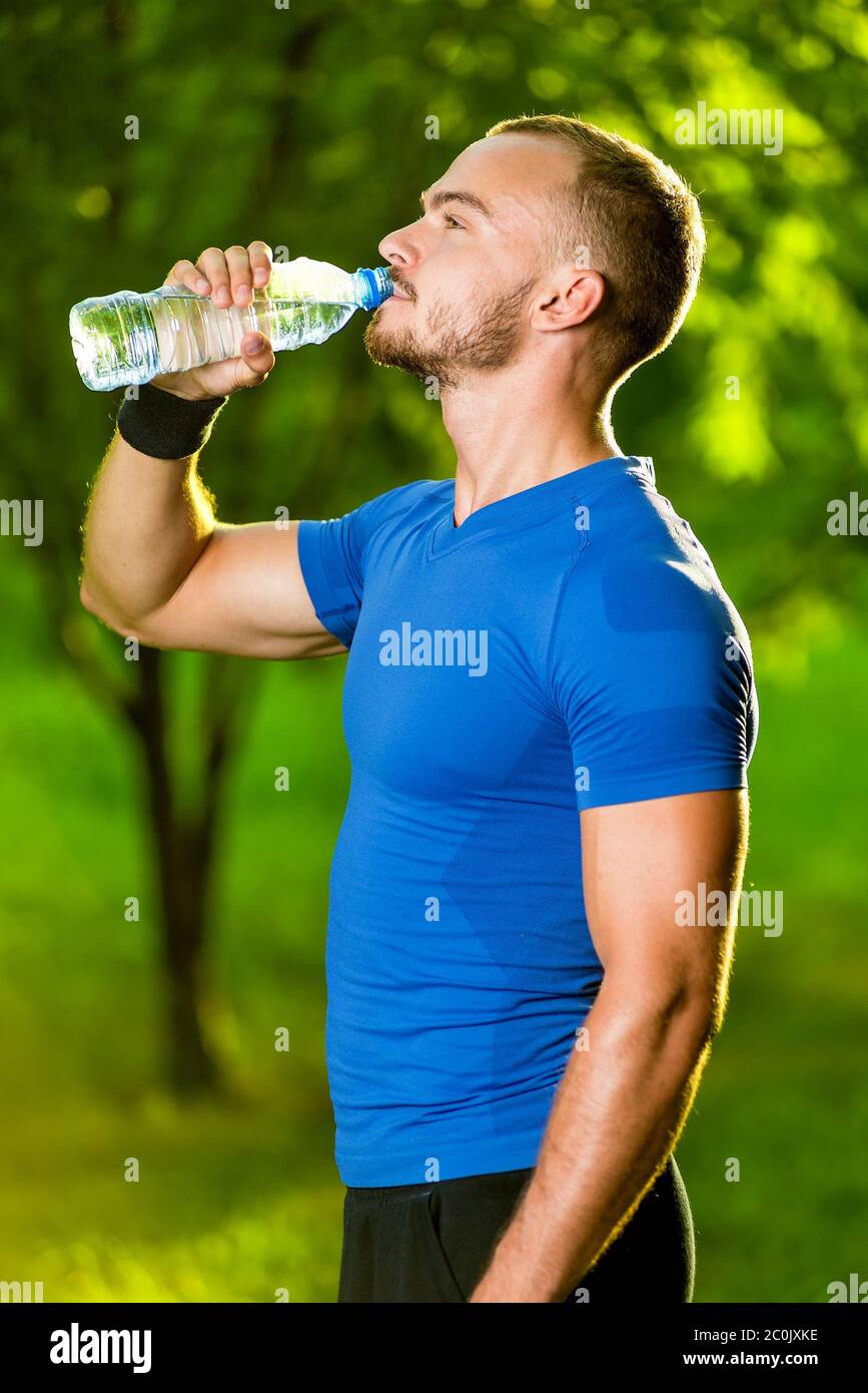 Athletic mature man drinking water from a bottle Stock Photo
