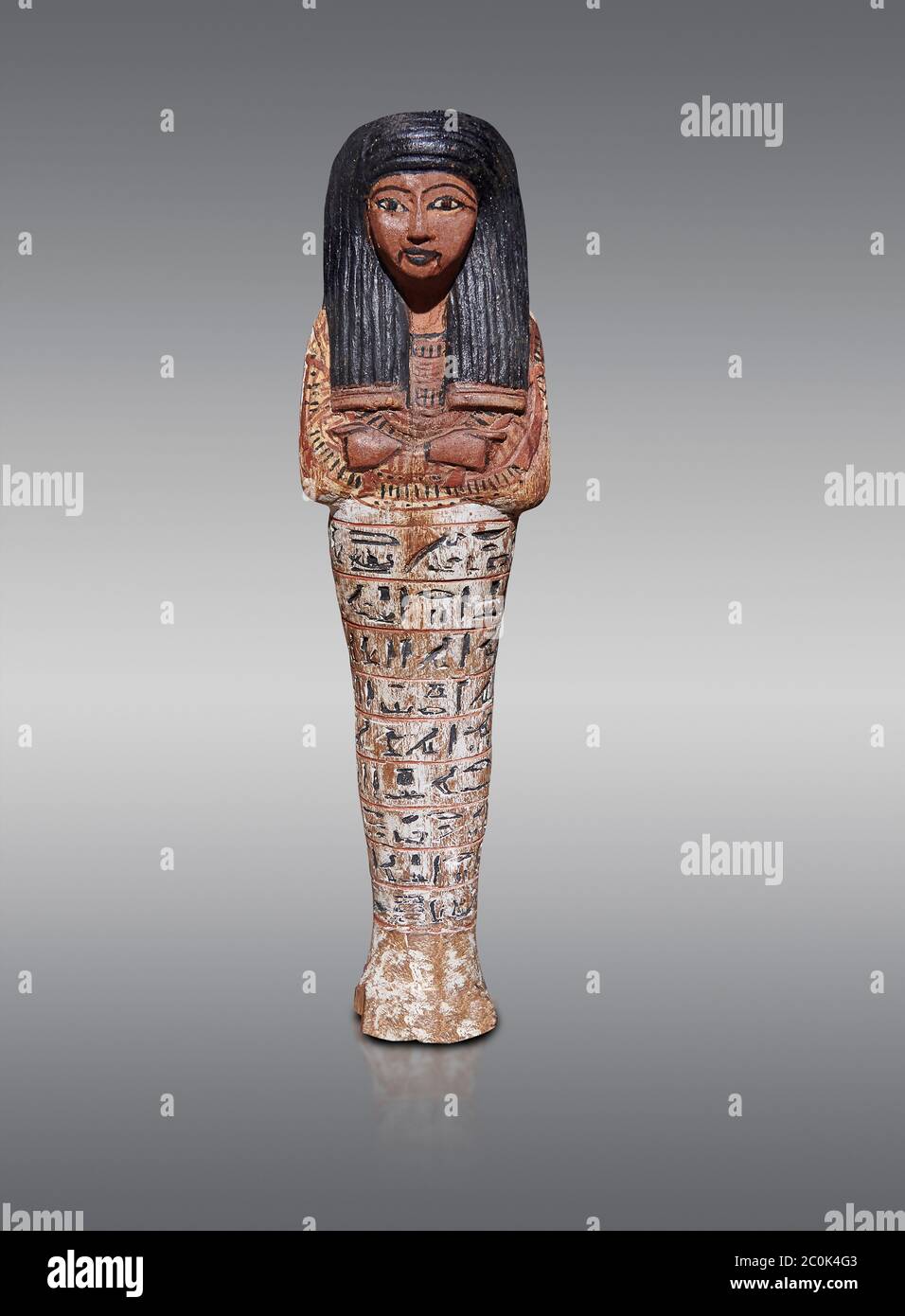 Ancient Egyptian shabtis doll, New Kingdom,. Egyptian Museum, Turin. Grey background. Stock Photo