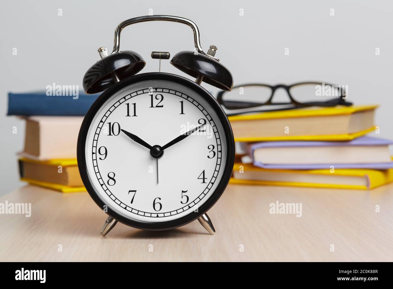 Back to school background with books and alarm clock Stock Photo - Alamy