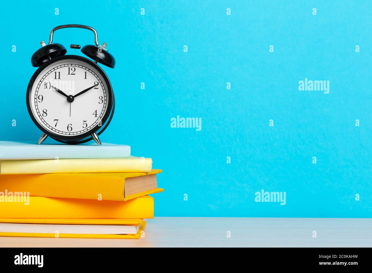 Back to school background with books and alarm clock Stock Photo - Alamy