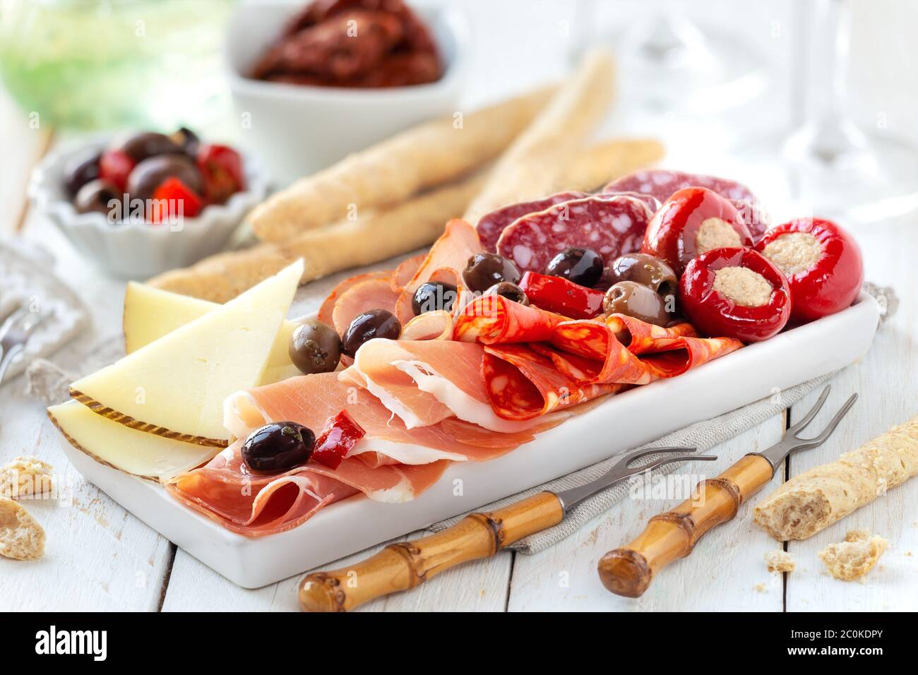 Delicious meat platter with cheese, spicy olives and stuffed cherry