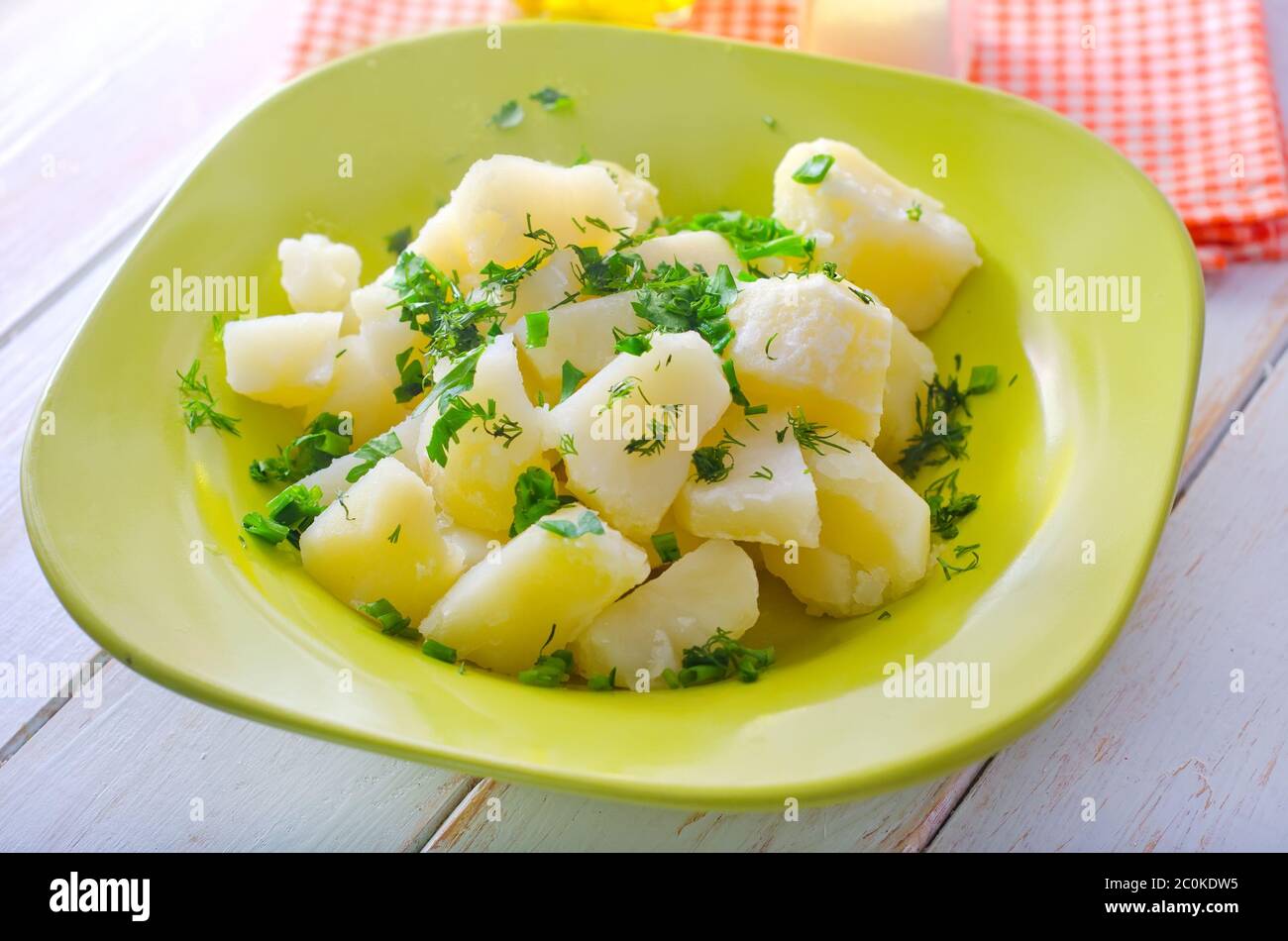boiled potato with greens in the green plate Stock Photo
