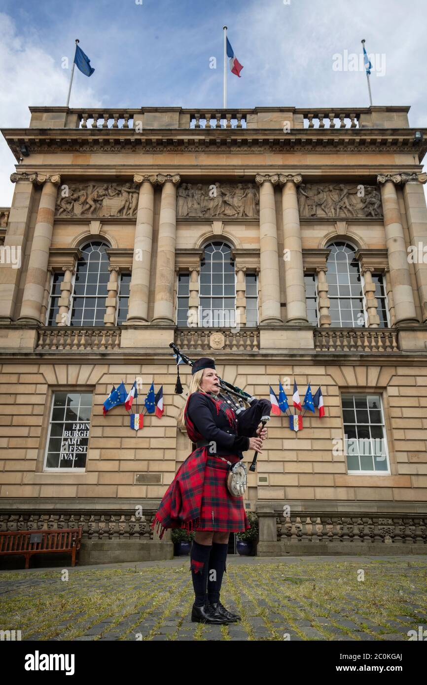 Piper Louise Marshall plays the pipers' march 'Heroes of St Valery' outside the Consulate General of France building in Edinburgh during the St Valery commemoration to remember the thousands of Scots who were killed or captured during 'the forgotten Dunkirk' 80 years ago. Stock Photo