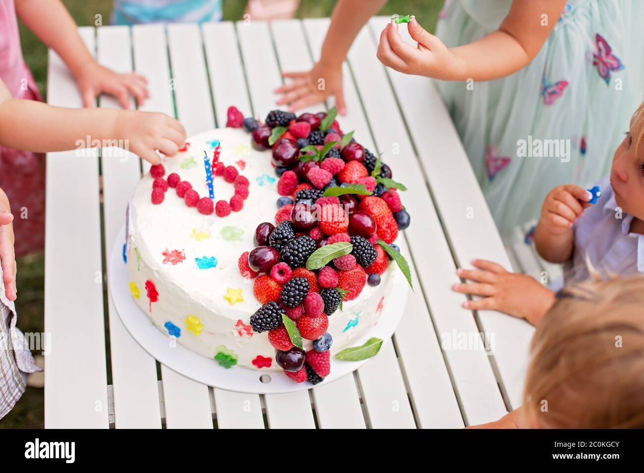 Children eating birthday cake hands hires stock photography and images