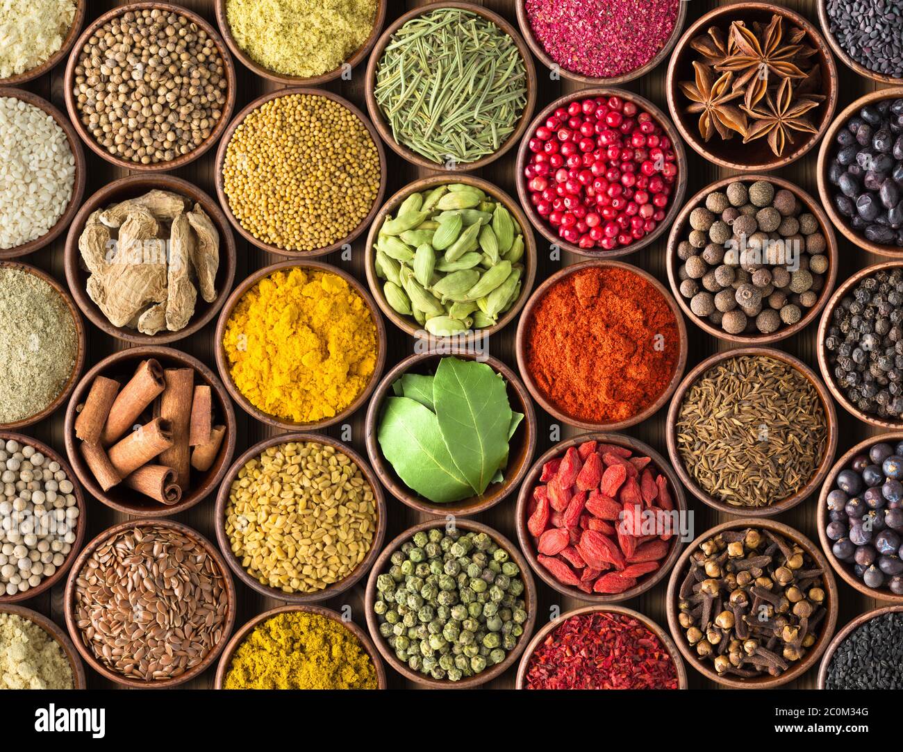 Colored spice background. Spices and herbs top view Stock Photo - Alamy