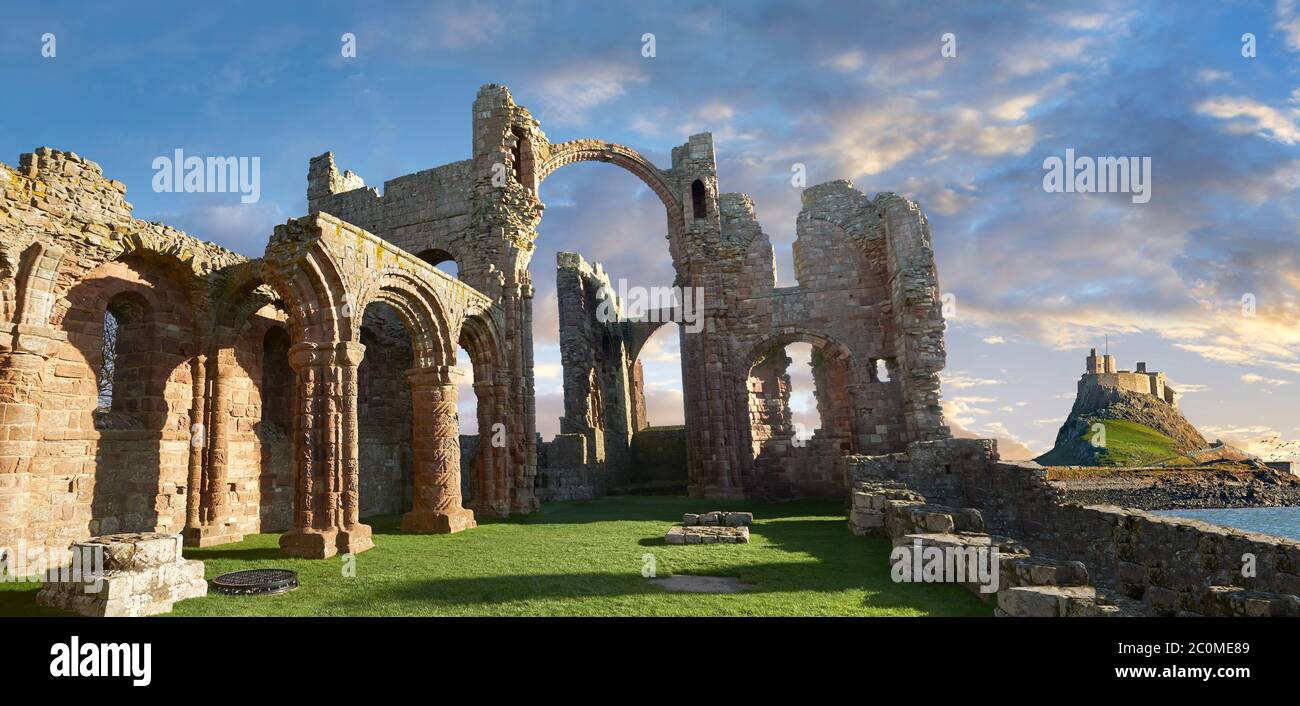 The Anglo Saxon Romanesque Lindisfarne Abbey ruins looking to Lidisfarne Castle,  Holy Island, Lindisfarne, Northumbria, England Stock Photo