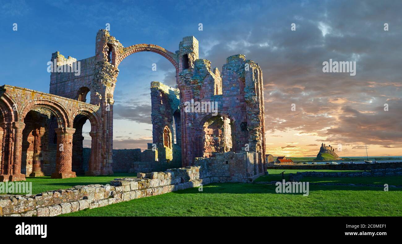 The Anglo Saxon Romanesque Lindisfarne Abbey ruins at sunset,  Holy Island, Lindisfarne, Northumbria, England Stock Photo