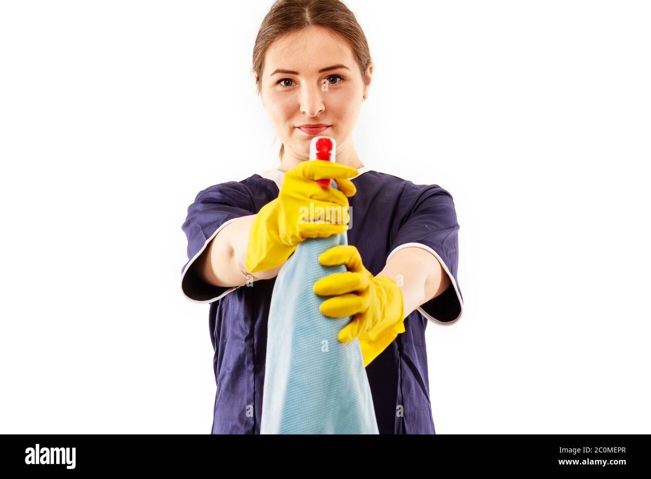 Young woman in apron isolated on white background. Cleaning concept ...