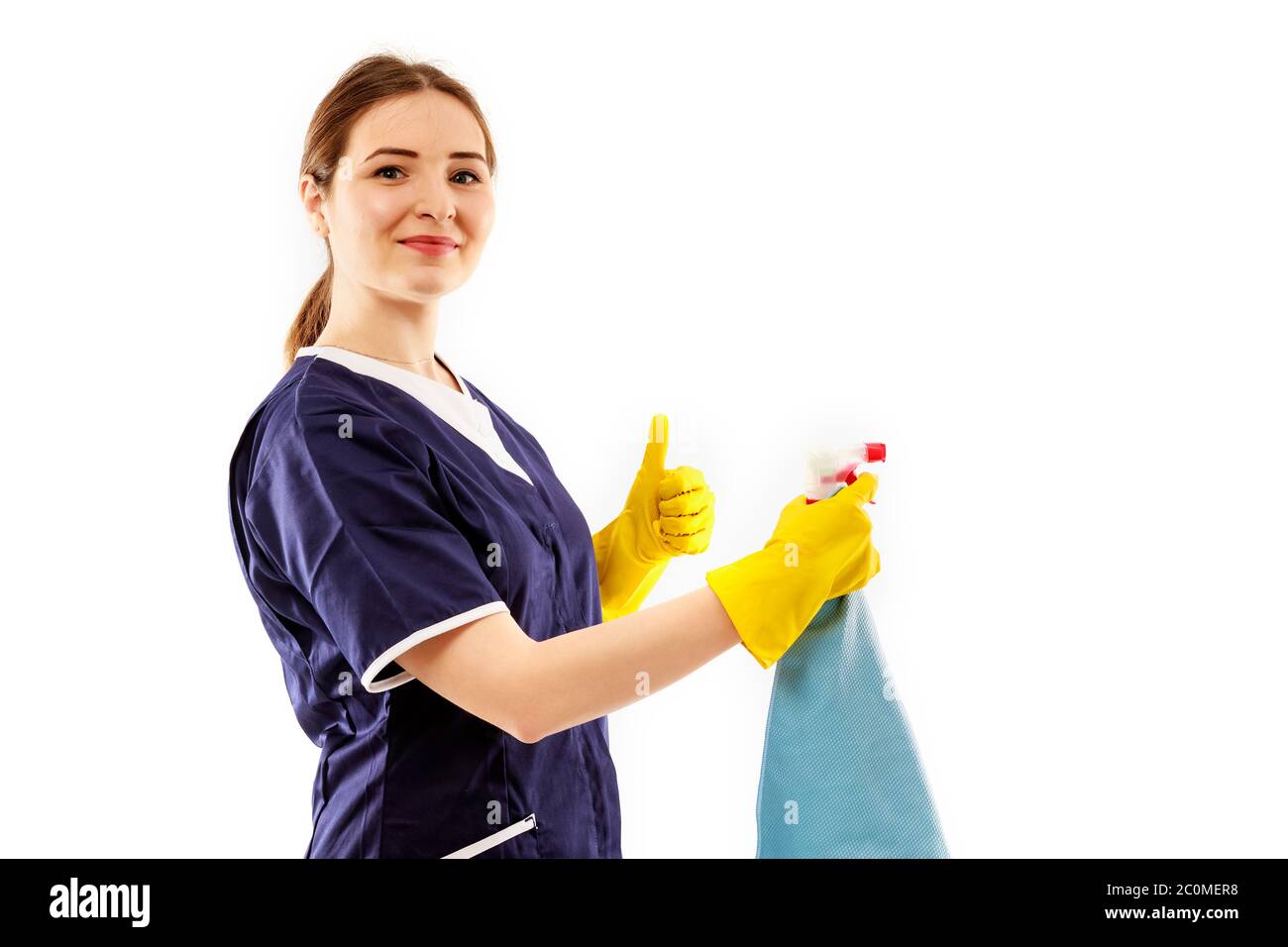 Young woman in apron isolated on white background. Cleaning concept ...