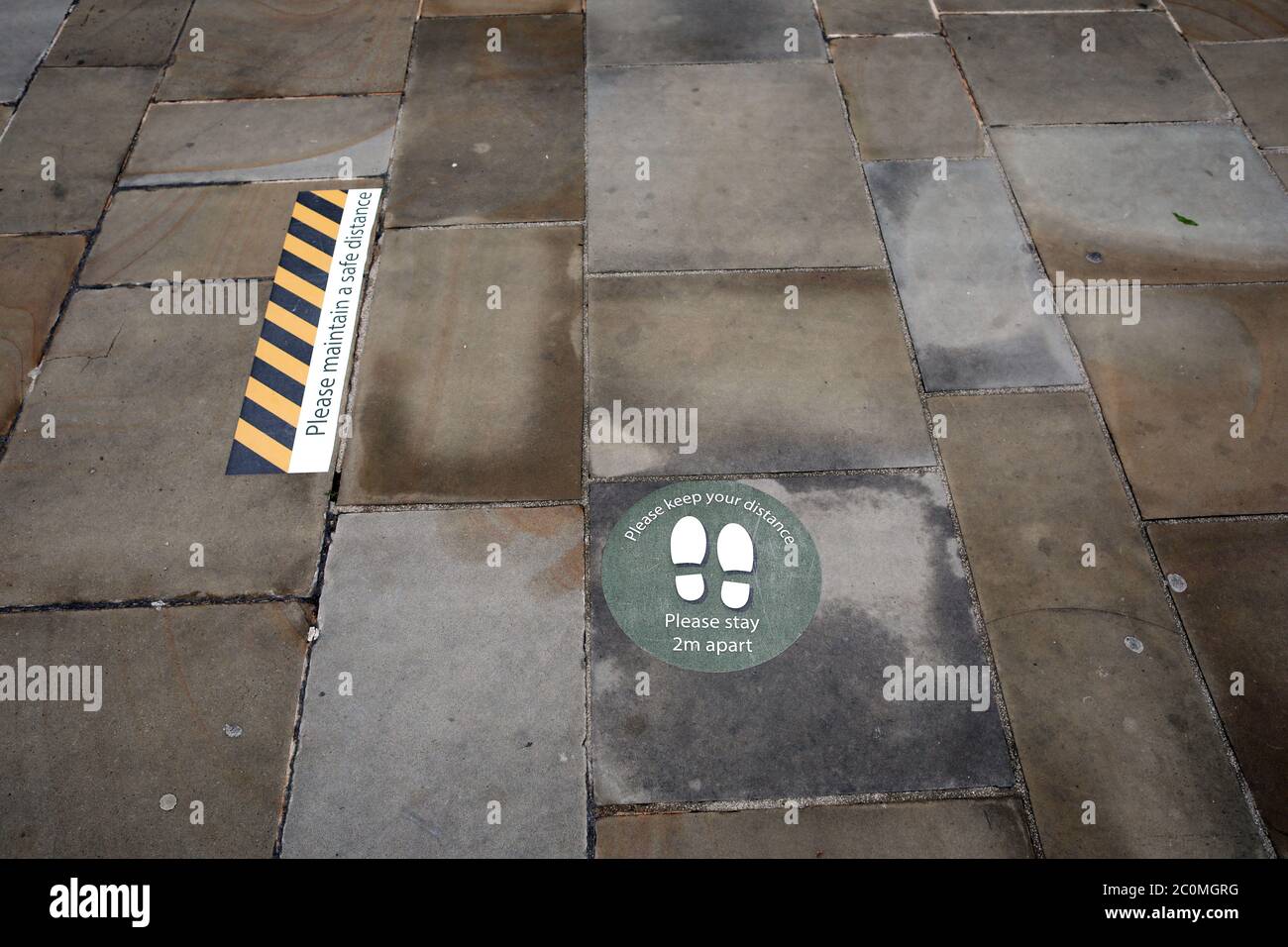 Peterborough, UK. 12th June, 2020. Day Eight One of Lockdown, in Peterborough, as the city centre is still very quiet with many shops remaining closed, but hoping to re-open on Monday June 15, as the lockdown rules are lifted a bit more. Social distancing stickers on Cathedral Square. Credit: Paul Marriott/Alamy Live News Stock Photo