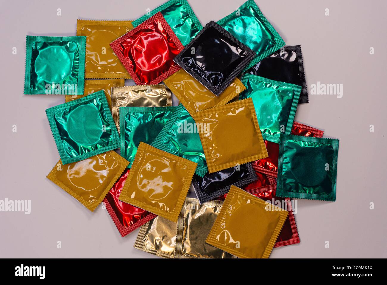 Display of colored condoms on a rotating platform arranged in bulk Stock Photo