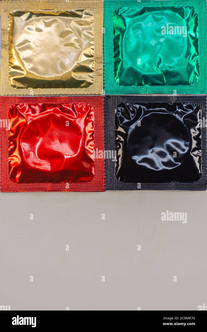 Display of colored condoms arranged neatly on a platform Stock Photo