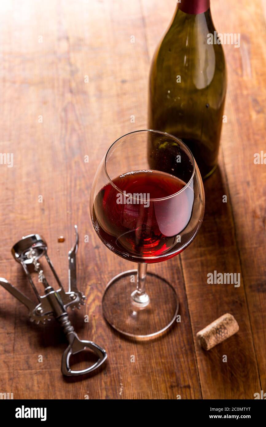 Red wine bottle, corks and corkscrew Stock Photo