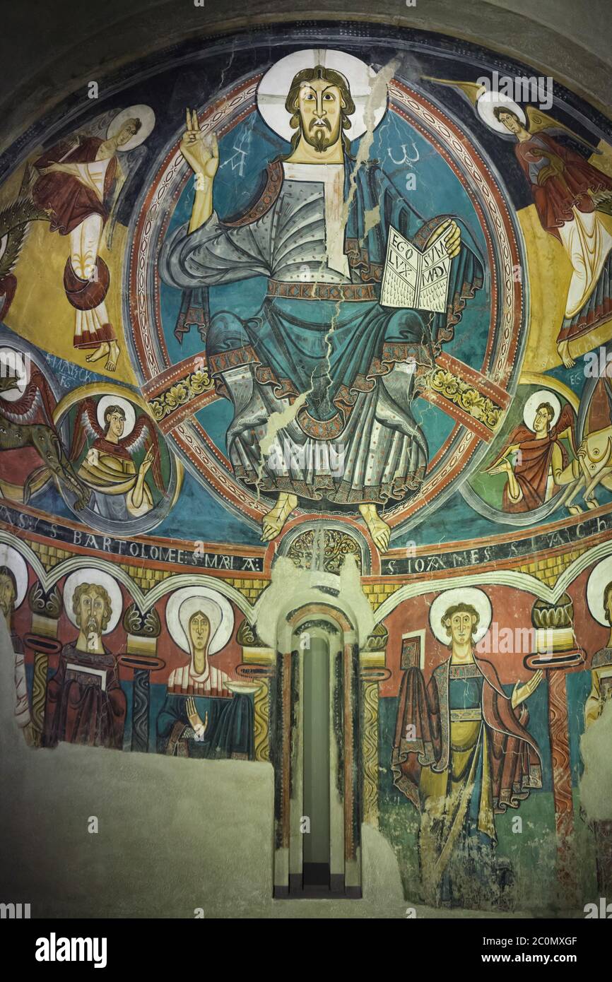 Jesus Christ in Majesty depicted in the medieval Romanesque fresco finished before 1123 from the church of Sant Climent de Taüll in the area of Vall de Boí in Alta Ribagorça in Catalonia, Spain, now on display in the National Art Museum of Catalonia (Museu Nacional d'Art de Catalunya) in Barcelona, Catalonia, Spain. Stock Photo