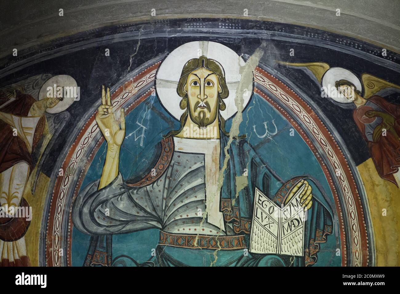Jesus Christ in Majesty depicted in the medieval Romanesque fresco finished before 1123 from the church of Sant Climent de Taüll in the area of Vall de Boí in Alta Ribagorça in Catalonia, Spain, now on display in the National Art Museum of Catalonia (Museu Nacional d'Art de Catalunya) in Barcelona, Catalonia, Spain. Stock Photo
