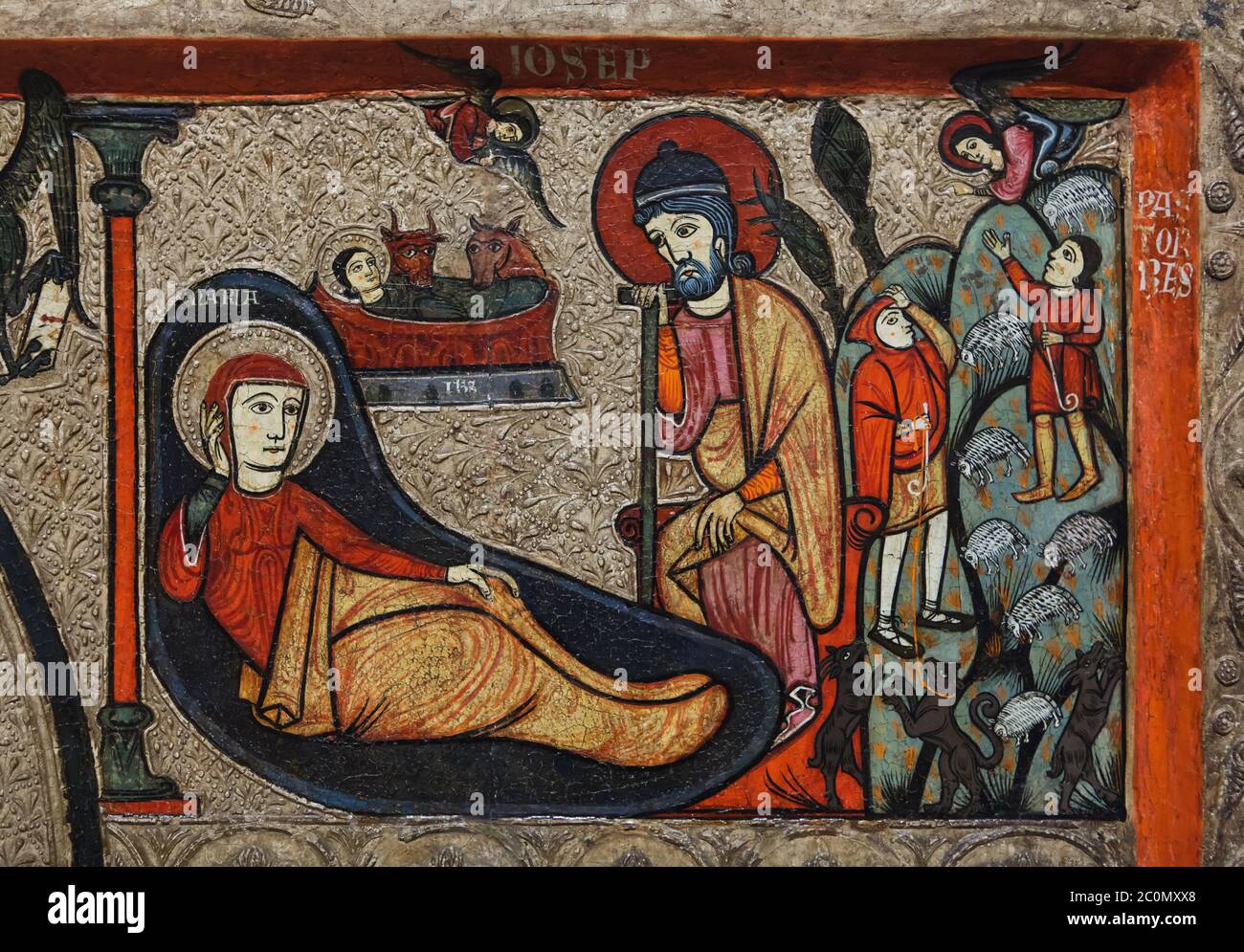 Nativity scene (L) and the Annunciation of the Shepherds (R) depicted in the Romanesque antependium (altar frontal), known as the Antependium from Cardet dated from the second half of the 13th century originally from the church of Santa Maria de Cardet in the area of Vall de Boí in Alta Ribagorça in Catalonia, Spain, now on display in the National Art Museum of Catalonia (Museu Nacional d'Art de Catalunya) in Barcelona, Catalonia, Spain. Stock Photo