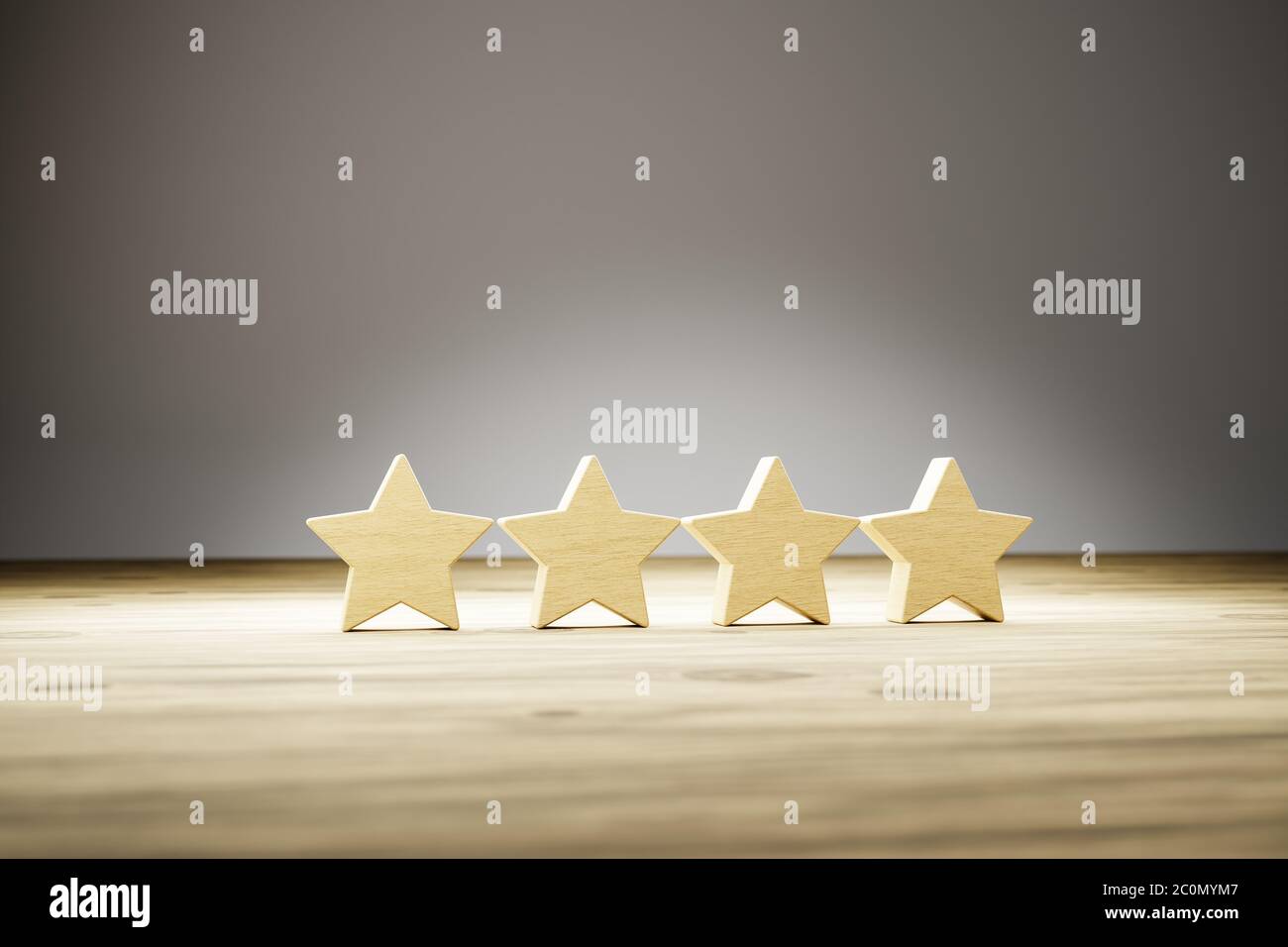 Four star rating: four wooden stars in a row on a wooden table with gray background. Selective focus. Concept shot for rating / reviews. Stock Photo