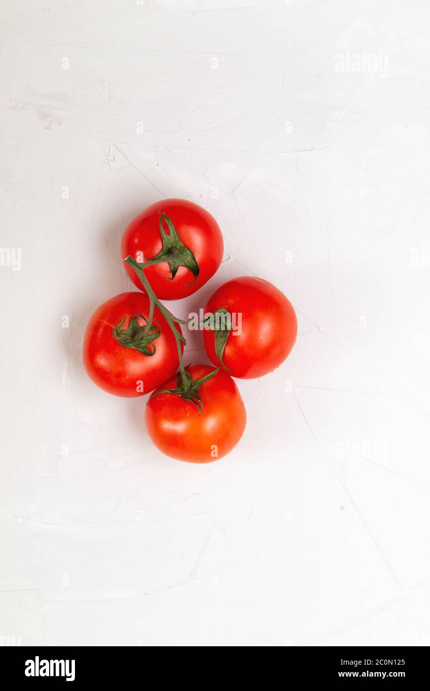 Red fresh organic tomatoes bunch on a white background Stock Photo - Alamy