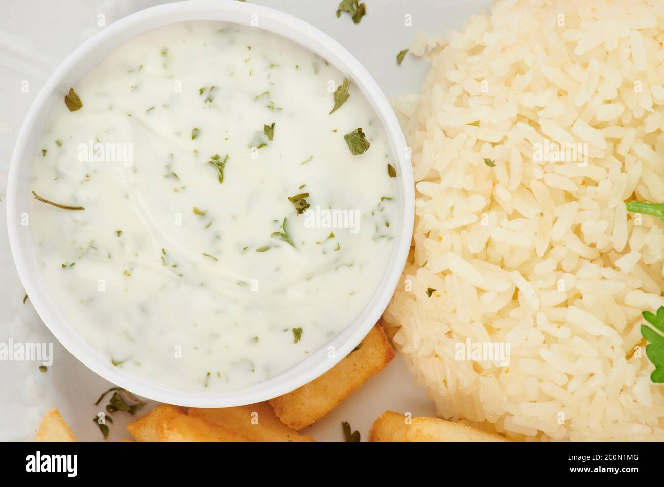 Tartar sauce with rice and french fries close up view Stock Photo
