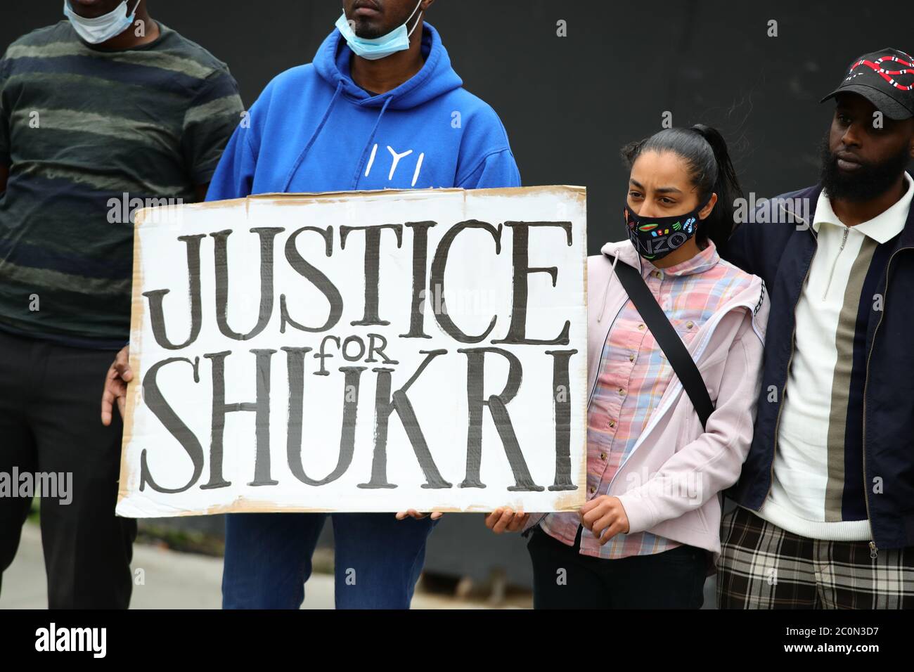 Members of the Justice for Shukri campaign at the unveiling of a Black Lives Matter UK (BLMUK) billboard on Westminster Bridge Road, London, which lists more than 3000 names of people who have died in police custody, prisons, immigration detention centres and in racist attacks in the UK, as well as those who have died as the result of coronavirus. The billboard has been erected by BLMUK, in collaboration with the United Families and Friends Campaign, Justice for Belly, Justice for Shukri, Migrants Organise and the Grenfell Estate. Stock Photo