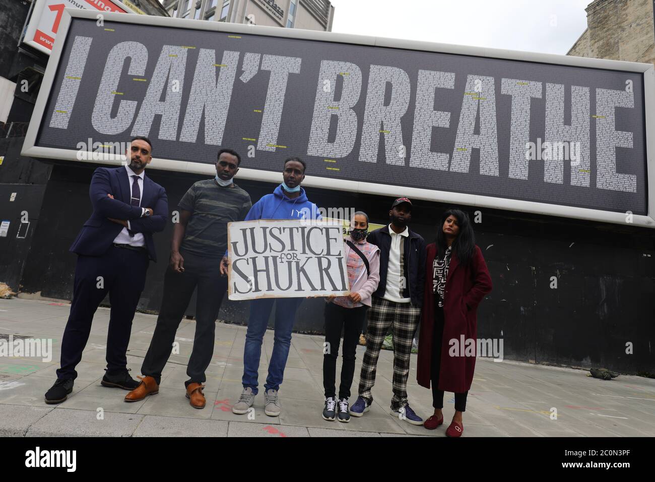 Members of the Justice for Shukri campaign at the unveiling of a Black Lives Matter UK (BLMUK) billboard on Westminster Bridge Road, London, which lists more than 3000 names of people who have died in police custody, prisons, immigration detention centres and in racist attacks in the UK, as well as those who have died as the result of coronavirus. The billboard has been erected by BLMUK, in collaboration with the United Families and Friends Campaign, Justice for Belly, Justice for Shukri, Migrants Organise and the Grenfell Estate. Stock Photo