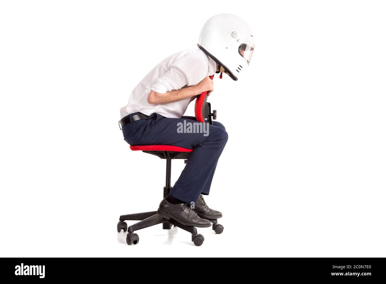 Businessman racing in an office chair with helmet, isolated in white ...