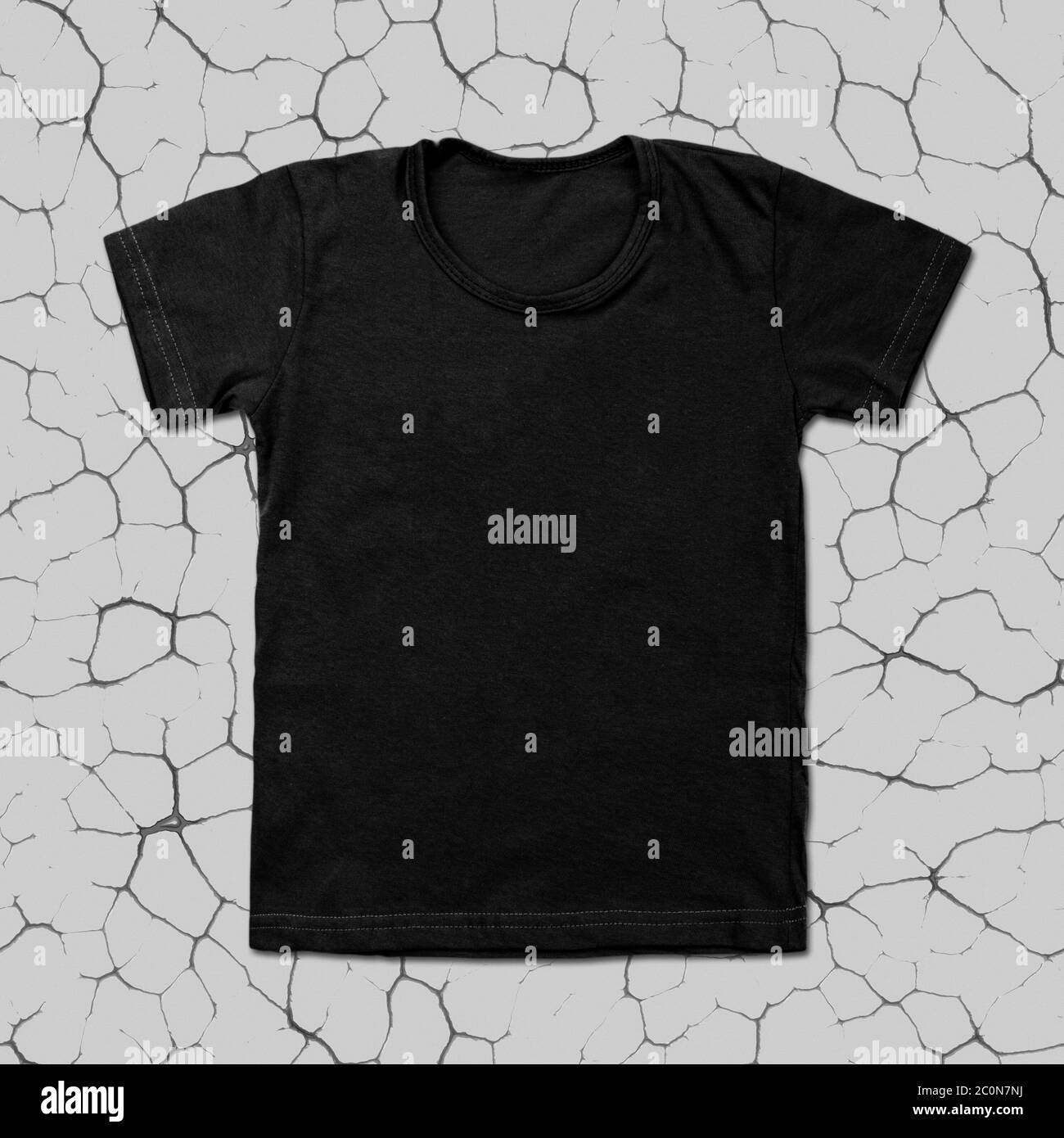 Black blank t-shirt on cracked background Stock Photo