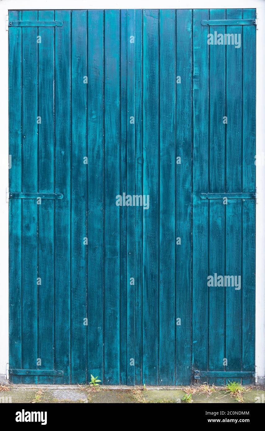 painted barn doors in two hues of blue Stock Photo