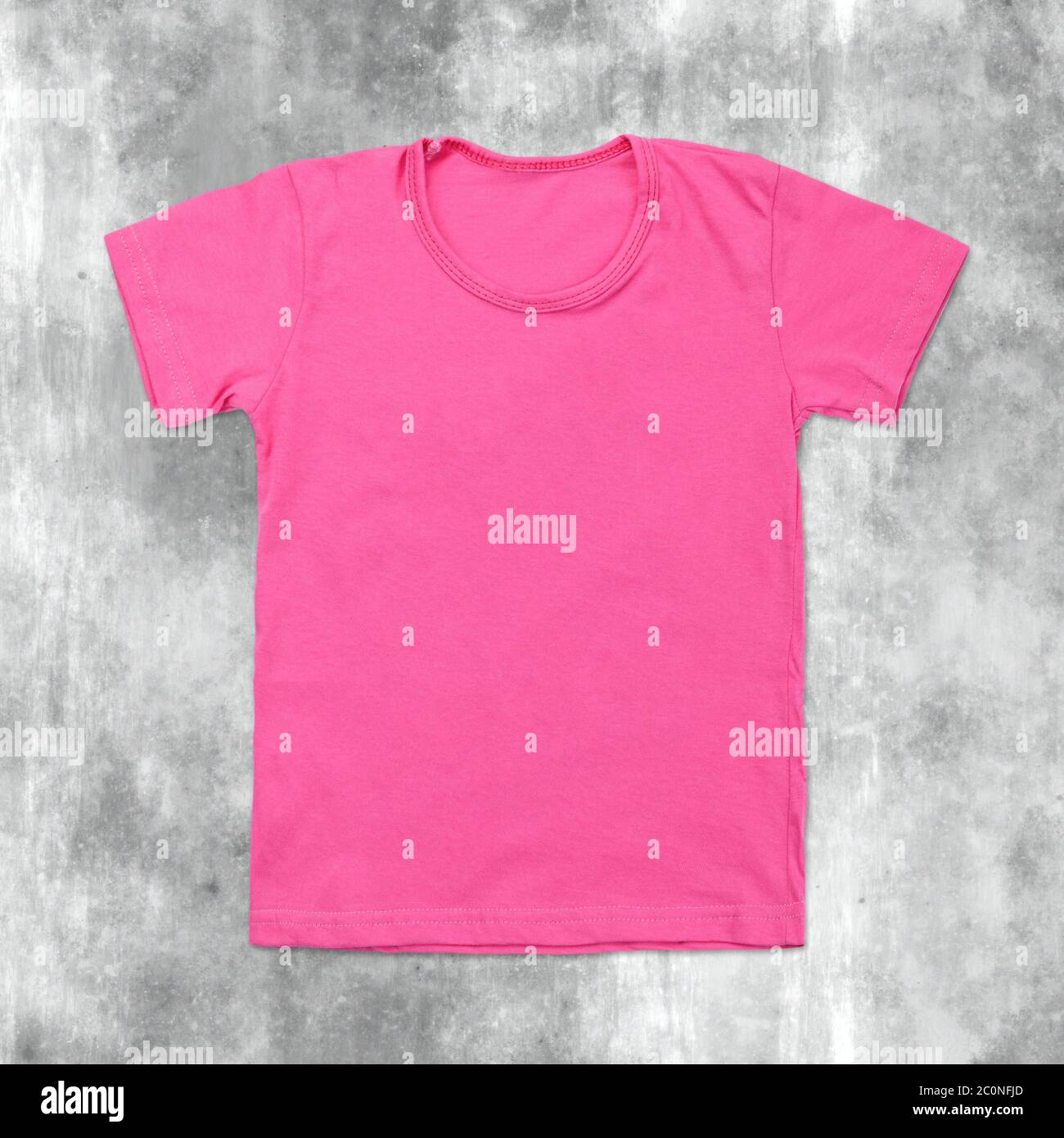 Pink blank t-shirt on dark cracked background Stock Photo
