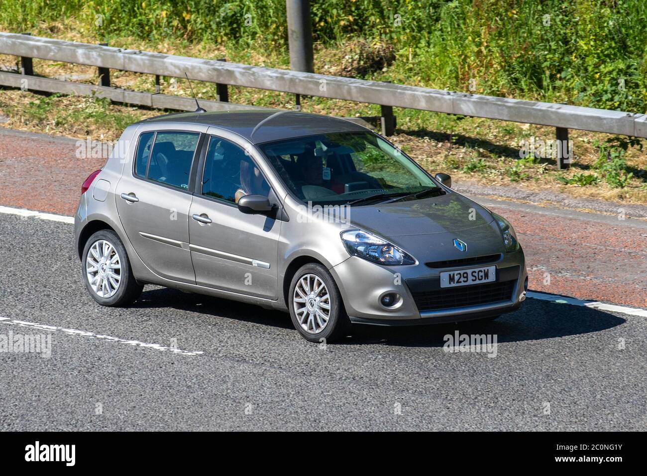 2011 beige Renault Clio Dynamique Tomtom DCI; Vehicular traffic moving vehicles, cars driving vehicle on UK roads, motors, motoring on the M6 motorway highway Stock Photo