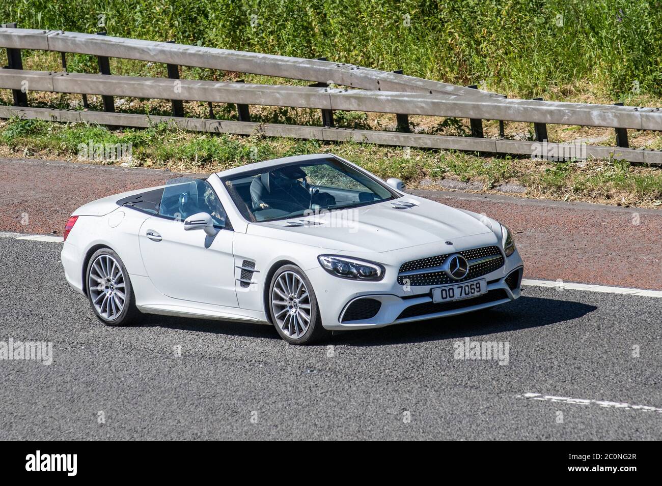 2012 white Mercedes-Benz SL 400 AMG Line Auto; Vehicular traffic moving vehicles, cars driving vehicle, convertible, convertibles, soft-top, open topped, roadster, cabriolets, drop-tops on UK roads, motors, motoring on the M6 motorway highway Stock Photo