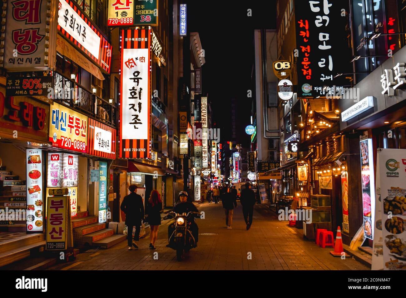 People walking in the neon light district in Myeongdong Seoul Korea Stock Photo
