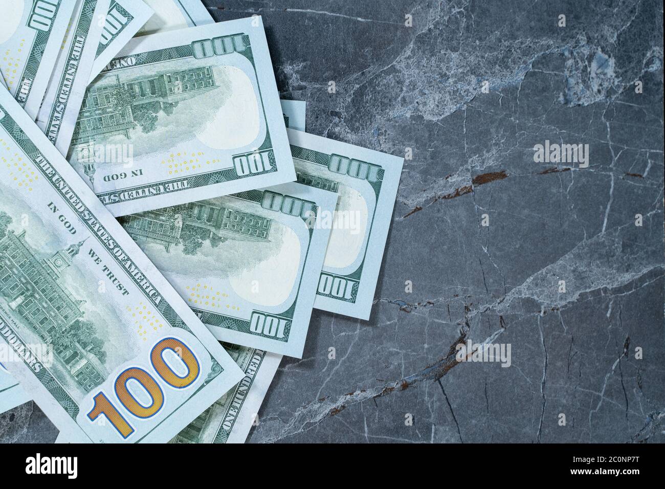dollars lying on a gray marble table Stock Photo