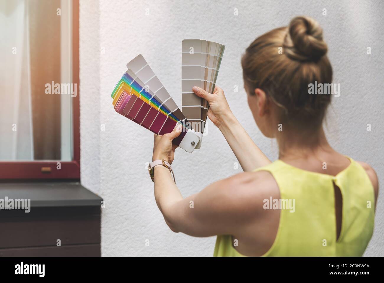 woman choosing paint color for house exterior facade Stock Photo