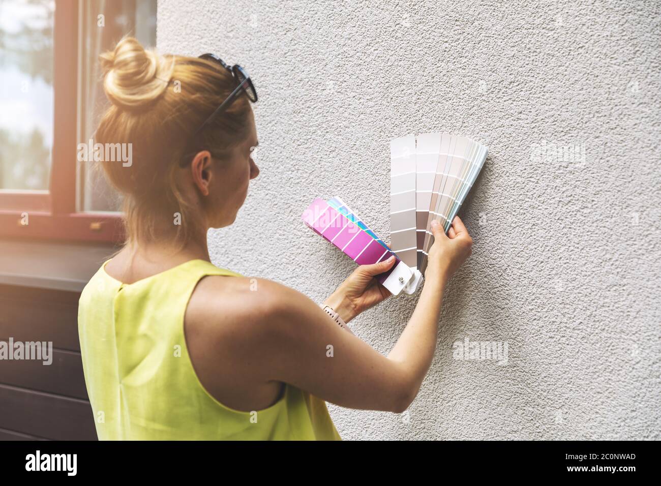 designer choosing paint color for house exterior stucco facade Stock Photo