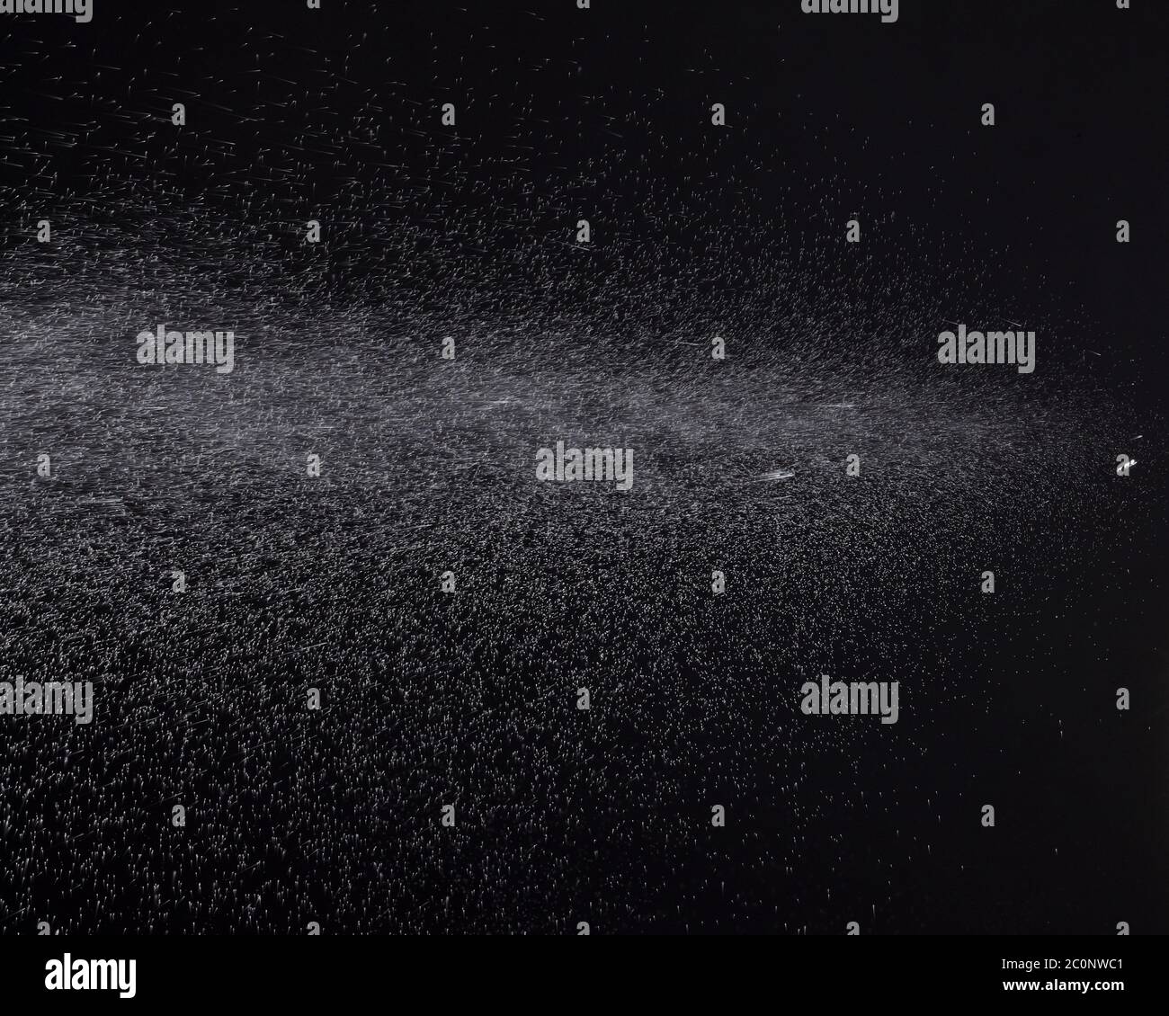 a spray of liquid in a black background Stock Photo Alamy