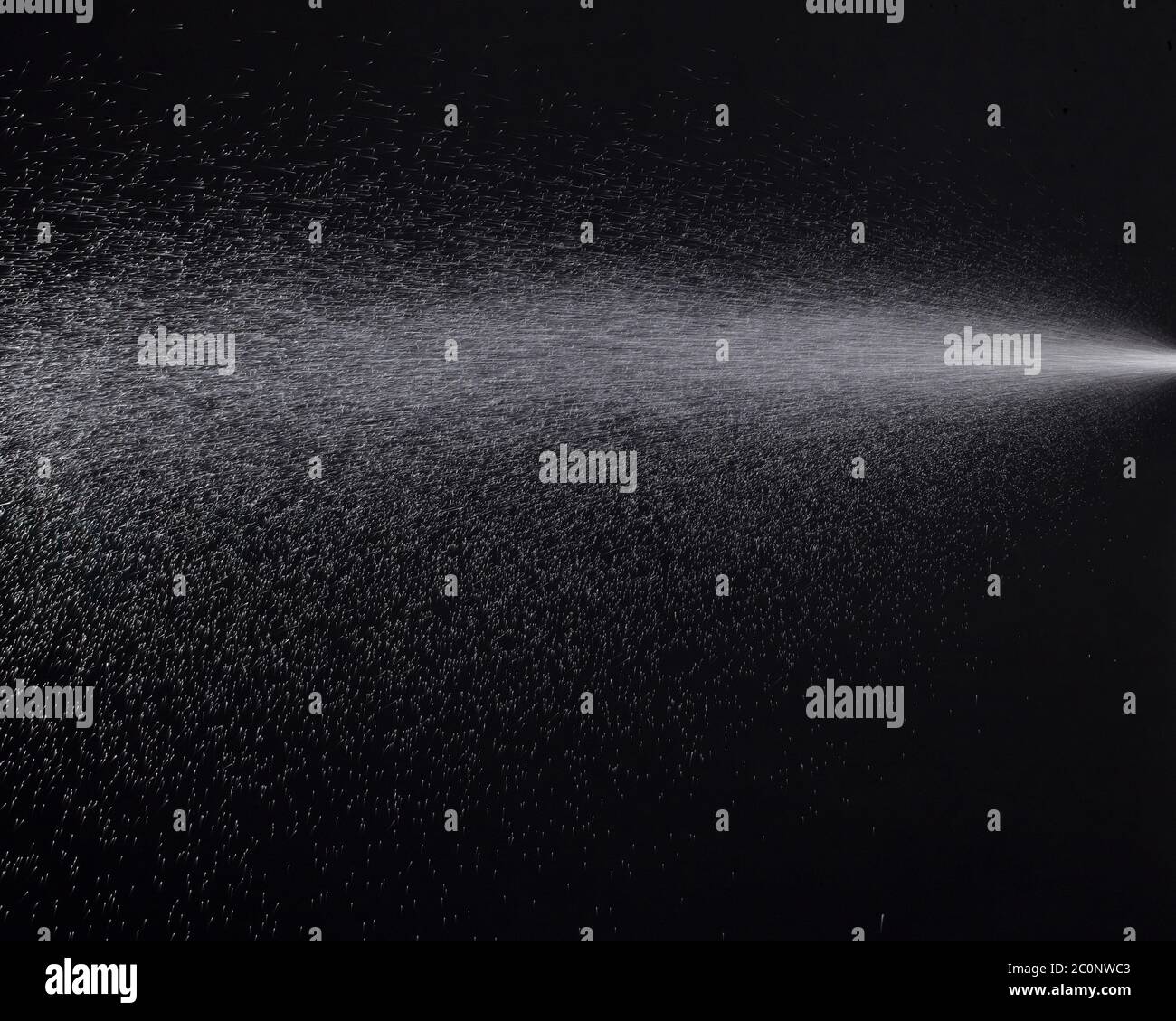 a spray of liquid in a black background Stock Photo Alamy